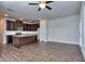 Open kitchen with dark wood cabinets, granite island, and stainless steel appliances at 6206 Ripple Way # 89, South Fulton, GA 30349
