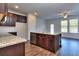 Modern kitchen with granite countertops, dark wood cabinets, and stainless steel appliances at 6206 Ripple Way # 89, South Fulton, GA 30349