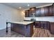 Open kitchen with island, granite counters and dark cabinets at 6206 Ripple Way # 89, South Fulton, GA 30349