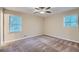 Well-lit bedroom with neutral carpeting and ceiling fan at 3993 Snapfinger Way, Decatur, GA 30035