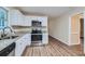 Modern kitchen with white cabinets, granite countertops, and stainless steel appliances at 3993 Snapfinger Way, Decatur, GA 30035
