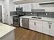 Modern white kitchen with stainless steel appliances and granite countertops at 1094 Amberglade Way, Douglasville, GA 30134