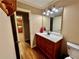 Bathroom with wood vanity, white countertop, and updated fixtures at 2000 Shadwell Way, Lawrenceville, GA 30043