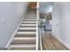Modern staircase with light wood treads and white risers at 6214 Ripple Way # 91, South Fulton, GA 30349