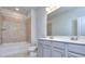 Bathroom with double vanity, gray cabinets, and a bathtub shower combo at 6214 Ripple Way # 91, South Fulton, GA 30349