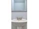 Modern bathroom with pedestal sink and silver framed mirror at 6214 Ripple Way # 91, South Fulton, GA 30349
