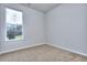 Well-lit bedroom with carpeting and a window at 6214 Ripple Way # 91, South Fulton, GA 30349