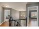 Upstairs hallway with hardwood floors, chandelier, and views to bedrooms at 206 Thorn Berry Way, Conyers, GA 30094