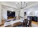 Formal dining room with chandelier, table, chairs, and view of home office at 4010 Toulon Ln, Cumming, GA 30040