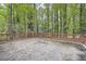 Private backyard with wooden deck and tree-filled landscape at 2184 Pemberton Sw Rd, Atlanta, GA 30331