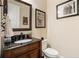 Stylish powder room with dark vanity and decorative mirror at 260 Trecastle Sq, Canton, GA 30114