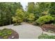 Expansive concrete driveway with circular design and landscape lighting at 2601 County Line Nw Rd, Acworth, GA 30101