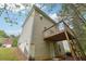 Tan vinyl-sided home with a deck and stairs leading to backyard at 4029 Riverside Pkwy, Decatur, GA 30034