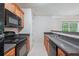 Kitchen with wood cabinets and black appliances at 4029 Riverside Pkwy, Decatur, GA 30034