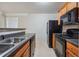 Modern kitchen with black appliances and wood cabinets at 4029 Riverside Pkwy, Decatur, GA 30034