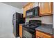 Kitchen features black appliances and wood cabinets at 4029 Riverside Pkwy, Decatur, GA 30034
