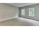 Spacious bedroom with light grey walls and carpet flooring at 7620 Breeze Bay Rd, Cumming, GA 30041