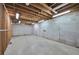 Unfinished basement with exposed beams and concrete floors at 220 Fox Hunter Dr, Alpharetta, GA 30022