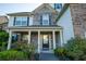 House exterior with stone and siding accents, covered porch at 1311 Cozy Cove Ln, Lawrenceville, GA 30045