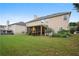 House back view, showcasing a large backyard and screened porch at 7110 Smithers Sw Way, South Fulton, GA 30331