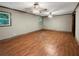 Spacious bedroom with wood-look flooring and ceiling fan at 5720 Deerfield Trl, Atlanta, GA 30349