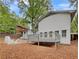 Home's backyard with deck and partially visible neighboring house at 5720 Deerfield Trl, Atlanta, GA 30349