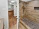 Modern bathroom with a walk-in shower and pebble floor at 5720 Deerfield Trl, Atlanta, GA 30349