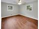 Spacious bedroom featuring hardwood floors and multiple windows at 5720 Deerfield Trl, Atlanta, GA 30349