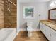 Updated bathroom with wood-look tile and granite vanity at 5720 Deerfield Trl, Atlanta, GA 30349