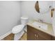 Basement bathroom with toilet, sink, and wood vanity at 5720 Deerfield Trl, Atlanta, GA 30349