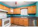 White appliances and light wood cabinets in this galley kitchen at 315 Watts Rd, Hiram, GA 30141