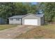 Gray house with blue shutters, attached garage, and a yard at 315 Watts Rd, Hiram, GA 30141