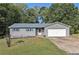Gray house with blue shutters, attached garage, and a yard at 315 Watts Rd, Hiram, GA 30141