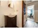 Small bathroom with dark vanity and a view to another room at 315 Watts Rd, Hiram, GA 30141