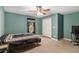 Bedroom with teal walls, ceiling fan, double closet, and carpeting at 315 Watts Rd, Hiram, GA 30141