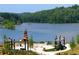 Lakefront community with a stone fireplace and seating areas at 318 Sandy Springs Cir # 360, Sandy Springs, GA 30328