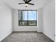 Bright bedroom with grey carpet, large window, and city view at 270 17Th Nw St # 1708, Atlanta, GA 30363