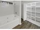 Bathroom featuring a soaking tub, tile shower, and built-in shelving at 1140 Independence Way, Norcross, GA 30093