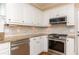 Kitchen with white cabinets, stainless steel appliances, and granite countertops at 8104 Greens Mill Way, Loganville, GA 30052