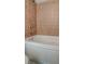 Clean bathroom with a large tub and updated tile at 238 Walker Sw St # 32, Atlanta, GA 30313