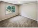 Well-lit bedroom featuring neutral walls and carpet at 709 Tribal Trl, Woodstock, GA 30188