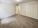 Spacious bedroom with double door closet and carpet at 709 Tribal Trl, Woodstock, GA 30188