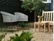 Relaxing patio area with woven chairs and a wooden bench at 2701 Southwell St, Atlanta, GA 30305