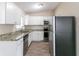 Kitchen with white cabinets, granite countertops, and stainless steel appliances at 1278 Lynwyn Se Ln, Atlanta, GA 30316