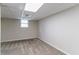 Clean, carpeted basement room with neutral walls and a window at 1278 Lynwyn Se Ln, Atlanta, GA 30316