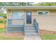 Front porch with gray railing and steps leading to the front door at 1278 Lynwyn Se Ln, Atlanta, GA 30316