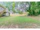 Large backyard with lush grass, mature trees, and wooden fence at 1278 Lynwyn Se Ln, Atlanta, GA 30316