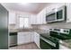 Modern kitchen featuring stainless steel appliances and granite countertops at 1278 Lynwyn Se Ln, Atlanta, GA 30316