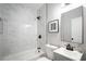 Clean bathroom with a white bathtub, marble tile, and modern fixtures at 943 Rose Sw Cir, Atlanta, GA 30310