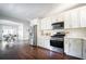 Modern kitchen with white shaker cabinets, stainless steel appliances, and hardwood floors at 943 Rose Sw Cir, Atlanta, GA 30310